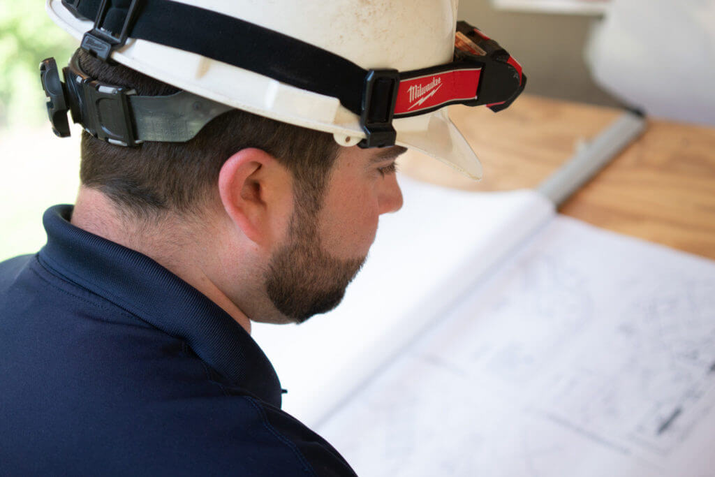 C & C worker focusing on construction drawings